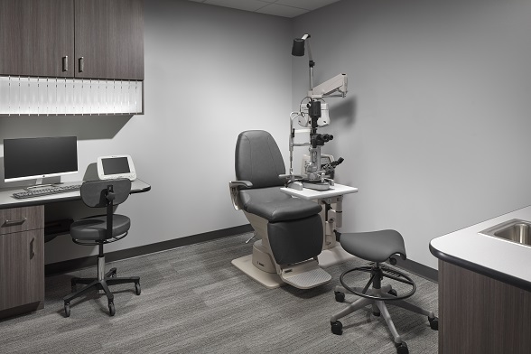 Modern exam room casework with integrated cable management — eliminating the cable forest that occupies up to 20% of lane floor space and creates tripping hazards.